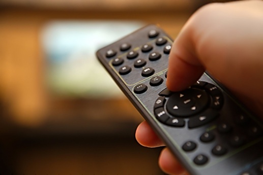 Television remote control on a wooden table